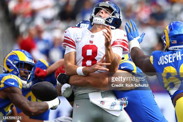 Leonard Floyd of the Los Angeles Rams strip sacks Daniel Jones of the New York Giants in the first quarter at MetLife Stadium on October 17, 2021 in...