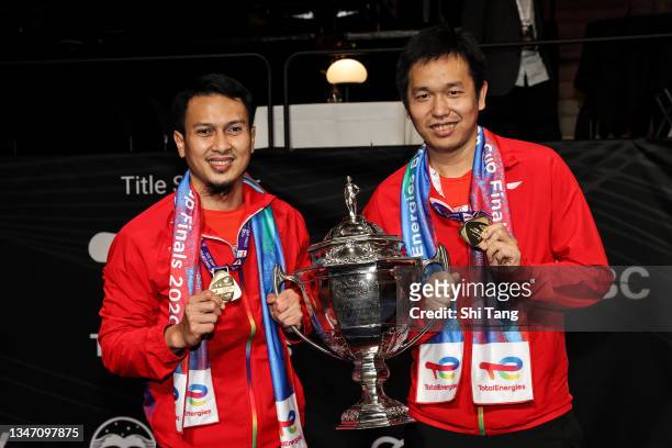Mohammad Ahsan and Hendra Setiawan of Indonesia pose with the trophy after the Thomas Cup final match against China Team during day nine of the...