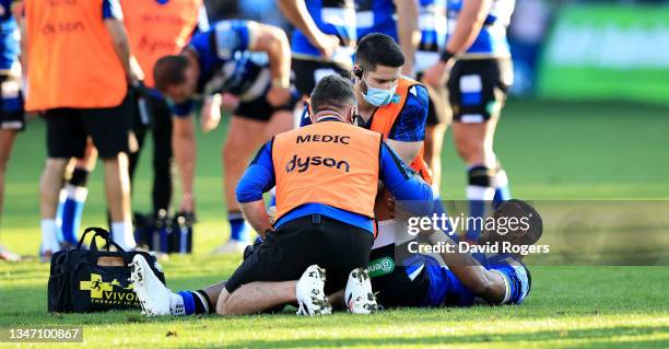 Anthony Watson of Bath receives attention to an injury on his left leg during the Gallagher Premiership Rugby match between Bath Rugby and Saracens...