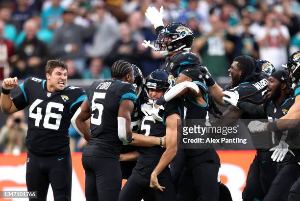 Matthew Wright of Jacksonville Jaguars celebrates with team mates after kicking the winning field goal during the NFL London 2021 match between Miami...