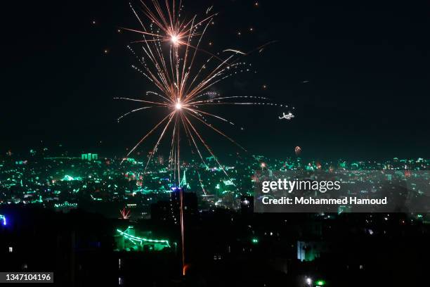 Fireworks over the city during celebrations on the eve of the Birthday of Prophet Muhammad on October 17, 2021 in Sana'a, Yemen. On 18 October,...