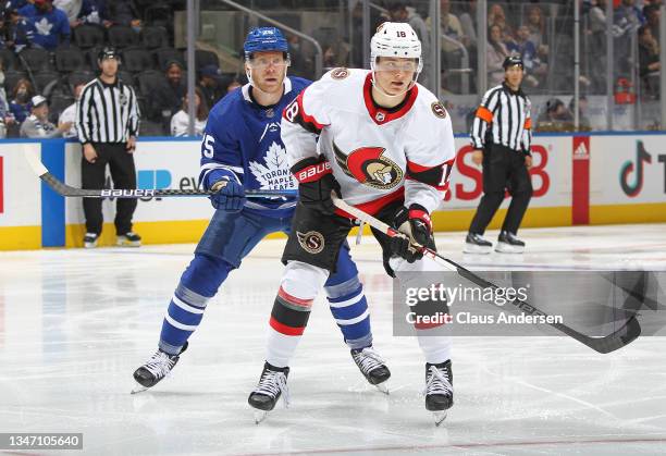 Tim Stutzle of the Ottawa Senators is watched closely by Ondrej Kase of the Toronto Maple Leafs during an NHL game at Scotiabank Arena on October 16,...