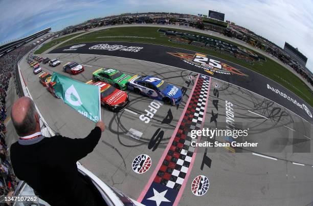 Kyle Larson, driver of the HendrickCars.com Chevrolet, leads Kyle Busch, driver of the Interstate Batteries Toyota, and Denny Hamlin, driver of the...