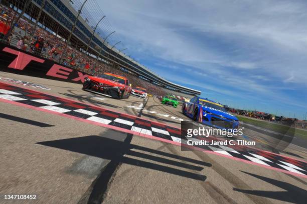 Kyle Larson, driver of the HendrickCars.com Chevrolet, and Denny Hamlin, driver of the Craftsman Toyota, lead the field on a pace lap prior to the...