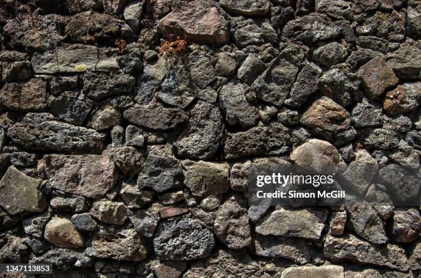 ancient stone and pebble mortar wall - stone wall texture stock pictures, royalty-free photos & images