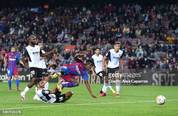 Ansu Fati of FC Barcelona is fouled by Jose Luis Gaya of Valencia CF which leads to a FC Barcelona penalty during the LaLiga Santander match between...