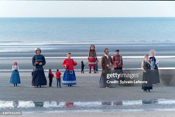 On Bray-Dunes beach, "Little Amal", a 3.5 meter giant puppet depicting a Syrian refugee girl, is joined by the giants of the North as she walks to...