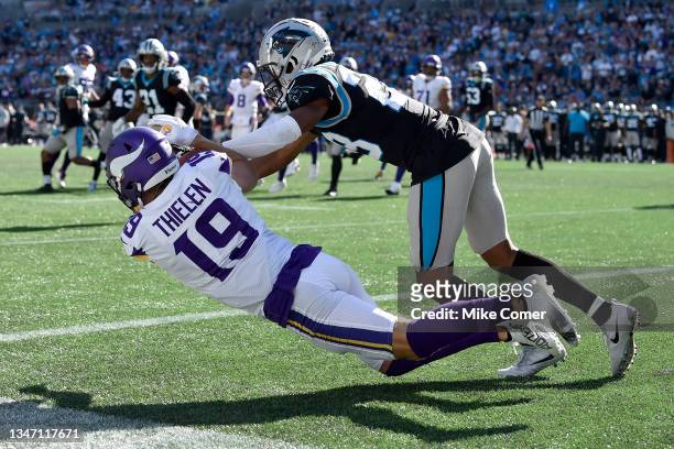 Adam Thielen of the Minnesota Vikings dives for a touchdown reception against Keith Taylor Jr. #28 of the Carolina Panthers during the third quarter...