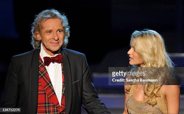 Thomas Gottschalk says good-bye to the audience while standing next to Michelle Hunziker during the 199th "Wetten dass...?" show at the Rothaus Hall...