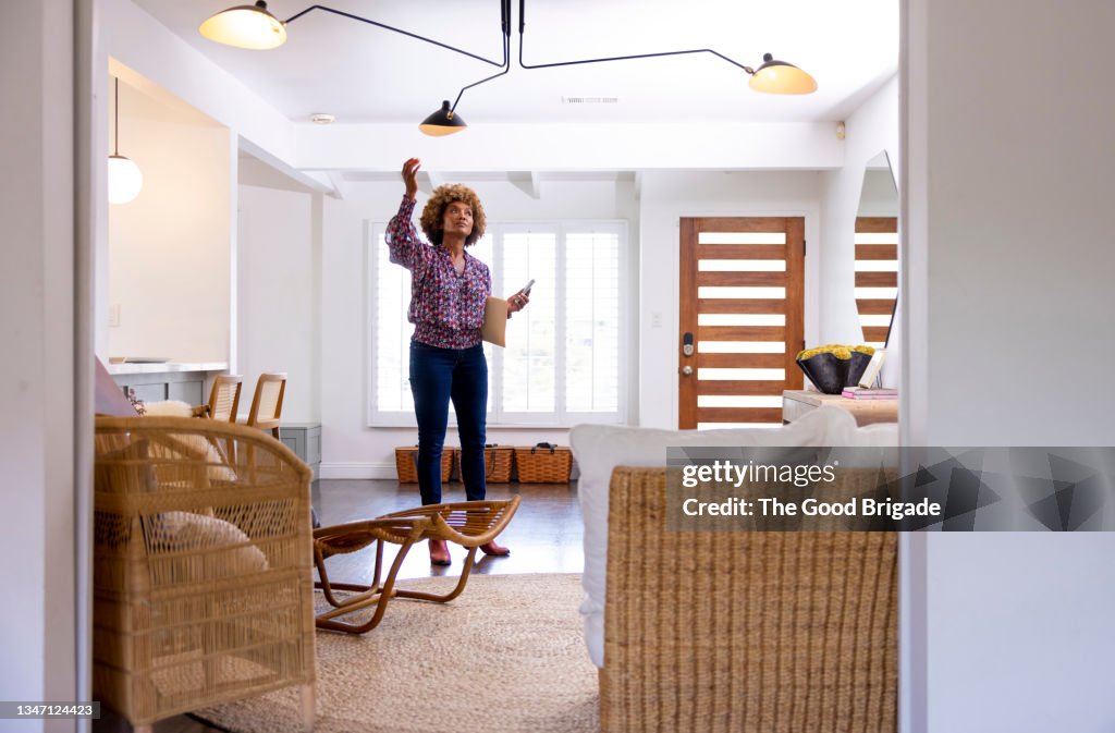 Full length of female real estate preparing for open house