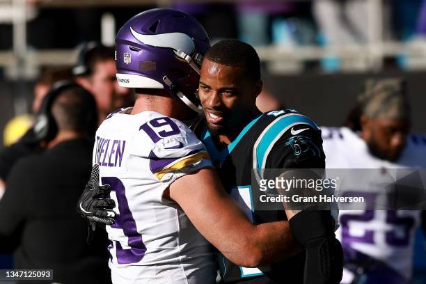 Adam Thielen of the Minnesota Vikings hugs A.J. Bouye of the Carolina Panthers after the game at Bank of America Stadium on October 17, 2021 in...