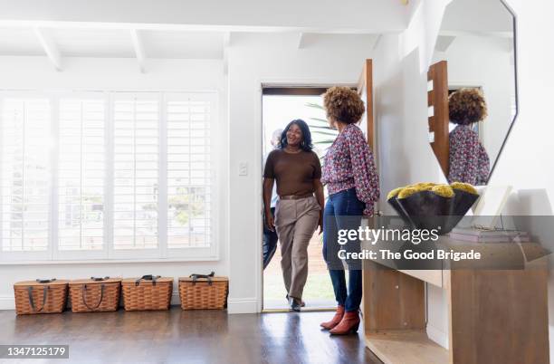 female real estate agent showing home to mature couple - ladies marketing day stock pictures, royalty-free photos & images