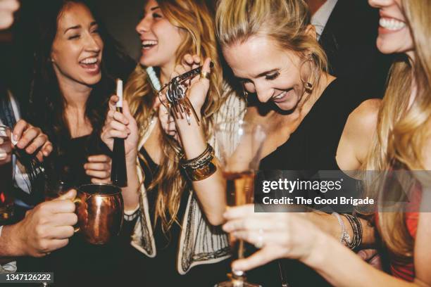 cheerful female friends enjoying together at party - party inside stockfoto's en -beelden