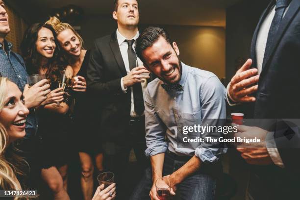 happy male and female friends talking while enjoying together at party - the party inside stock pictures, royalty-free photos & images