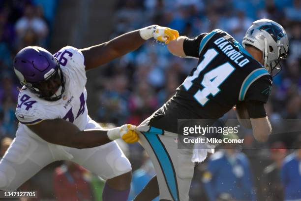 Sam Darnold of the Carolina Panthers escapes the tackle from Dalvin Tomlinson of the Minnesota Vikings during the second half at Bank of America...