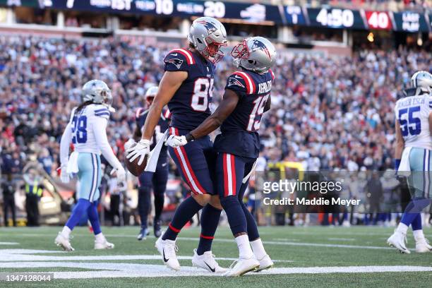 Hunter Henry of the New England Patriots celebrates with teammate Nelson Agholor after scoring a touchdown against the Dallas Cowboys in the first...