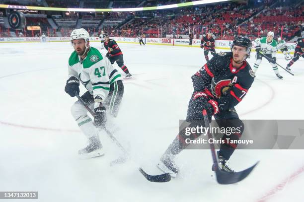 Alexander Radulov of the Dallas Stars battles for the puck with Thomas Chabot of the Ottawa Senators in the first period at Canadian Tire Centre on...