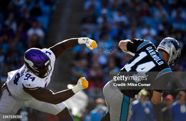 Sam Darnold of the Carolina Panthers escapes the tackle from Dalvin Tomlinson of the Minnesota Vikings during the fourth quarter at Bank of America...