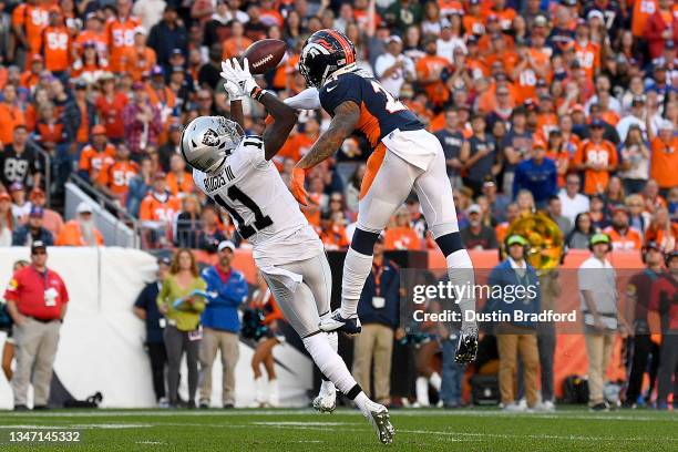 Henry Ruggs III of the Las Vegas Raiders completes a catch against Ronald Darby of the Denver Broncos during the third quarter at Empower Field At...