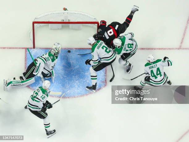 Josh Norris of the Ottawa Senators shot is saved on the goal line by Anton Khudobin of the Dallas Stars while his teammates Jani Hakanpaa, Michael...