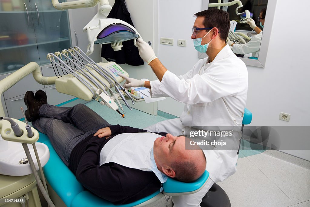 Dentist and middle aged patient.