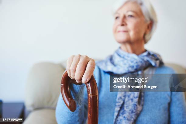 shot of a senior woman looking thoughtful at home - widow pension stock pictures, royalty-free photos & images