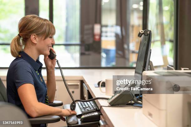 receptionist answering phones - sports venue employee stock pictures, royalty-free photos & images