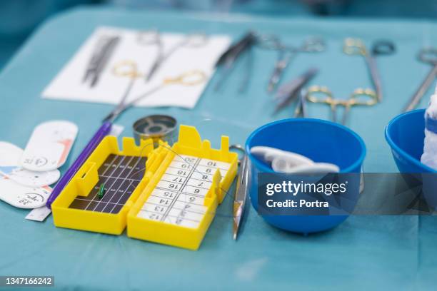 suture thread with needle box on medical tray - suture stock pictures, royalty-free photos & images