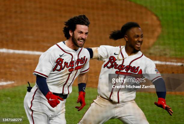Dansby Swanson and Ozzie Albies of the Atlanta Braves celebrate after Swanson scored the winning run against the Los Angeles Dodgers in the ninth...