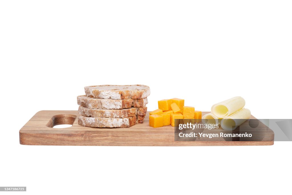Cutting board with cheese and bread isolated on white background