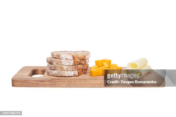 cutting board with cheese and bread isolated on white background - cheese board imagens e fotografias de stock