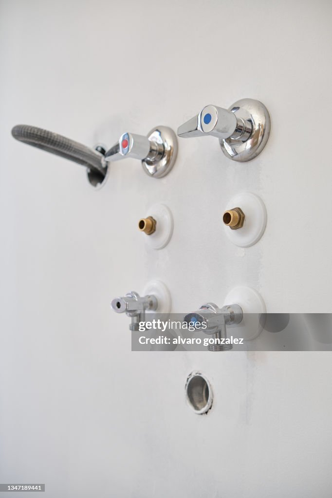 Faucet set installation in a new building. Faucet, stopcock, ball valve and drain.
