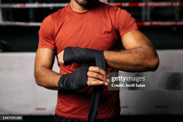 man wearing bandage in a gym - faustschlag stock-fotos und bilder