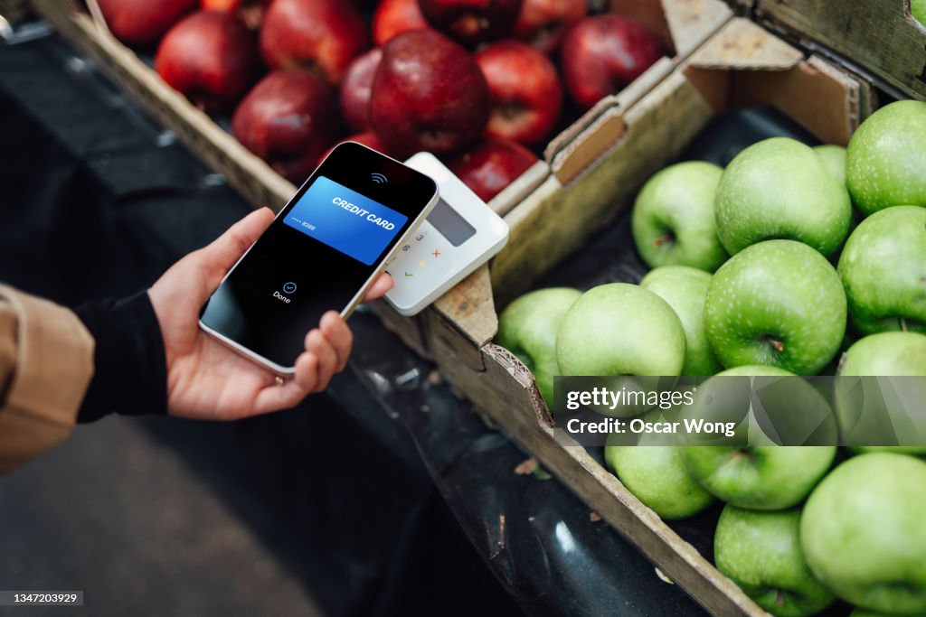 Making contactless payment with smart phone at farmers market