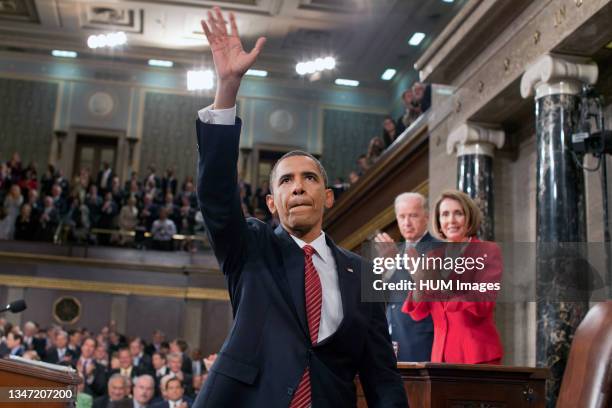 President Barack Obama waves to the First Lady and guests seated in the gallery of the House Chamber at the U.S. Capitol in Washington, D.C., Sept....