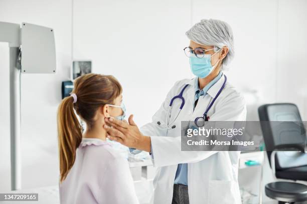 doctor examining girl in hospital - allmänläkare bildbanksfoton och bilder