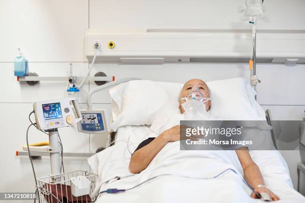 male on ventilator in hospital during covid-19 - apparecchio per la respirazione foto e immagini stock