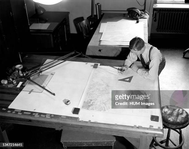 Map-making Division of Coast & Geodetic Survey, Dept of Commerce, cartographer in process of making a map circa 1940 .