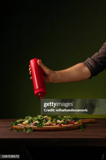 a splash of balsamic vinegar to finish the job - dessert topping stock pictures, royalty-free photos & images