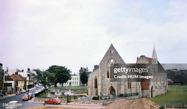 Cars parked outside Royal Garrison Church in Portsmouth England circa 1973 .