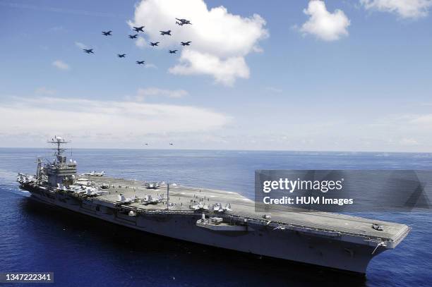 In the South China Sea, the US Navy Nimitz-class aircraft carrier USS ABRAHAM LINCOLN and aircraft assigned to Carrier Air Wing Two perform an aerial...
