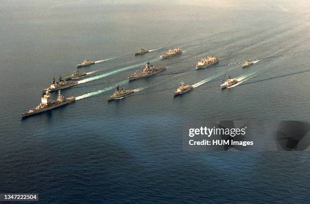 An aerial port bow view of the first battleship battle group to deploy to the Western Pacific since the Korean War underway with Australian ships...