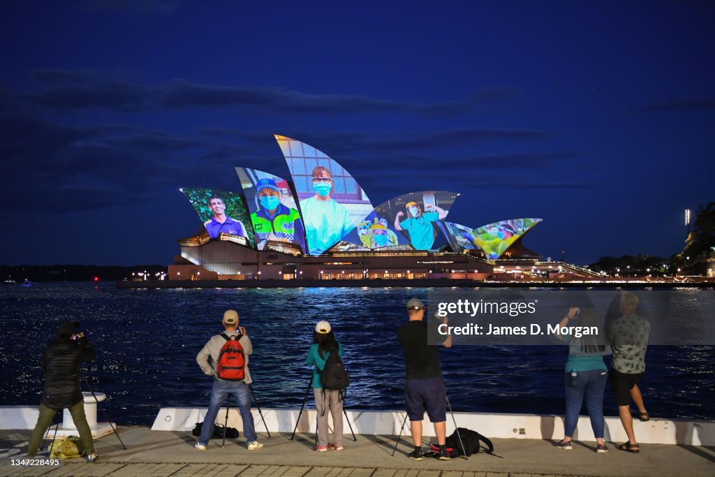 Sydney Opera House Sails Light Up In Tribute To Frontline Workers As NSW Reaches 80% Vaccine Milestone