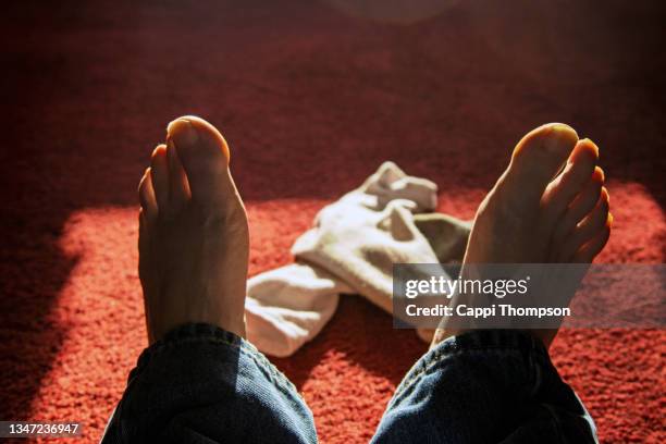 caucasian feet with dirty socks - man lying with sock fotografías e imágenes de stock