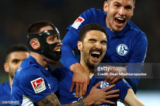 Marcin Kaminski of FC Schalke 04 celebrates scoring his teams first goal of the game in the final minute with Darko Churlinov and Marvin Pieringer...