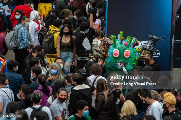 An attendee using a costume of the SarsCov2 virus virus, roams around more than a thousand people at the Corferias Fair Compund amidst COVID-19...