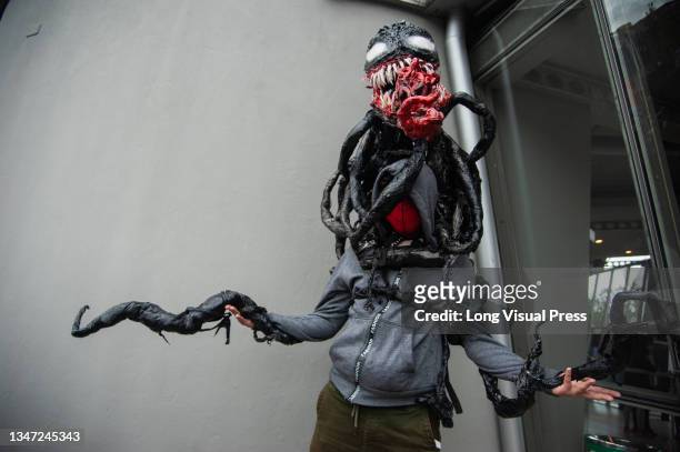 Marvel Comics fan poses for a photo using a VENOM Costume during the fourth day of the SOFA 2021, a fair aimed to the geek audience in Colombia that...