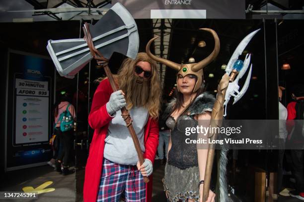 Couple dressed as Marvel characters Thor and Loki pose for a photo during the fourth day of the SOFA 2021, a fair aimed to the geek audience in...