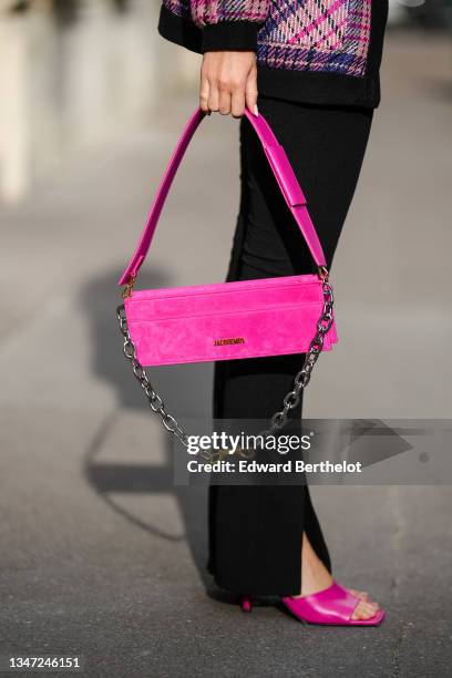 Katie Giorgadze wears front slit black flared leggings from Bershka, pink fuschia mules shoes from Zara, a long rigid box bag in pink "Le Ciuciu"...