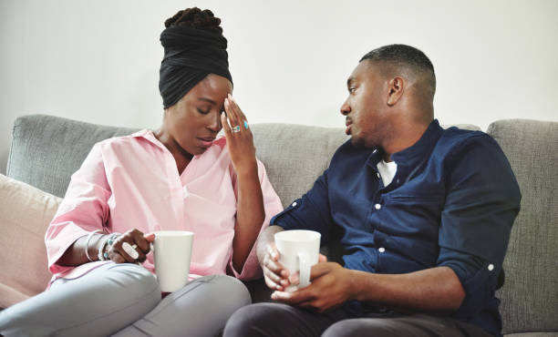 shot of a young couple spending discussing an issue on the sofa at home - wife cheating with black man stock pictures, royalty-free photos & images